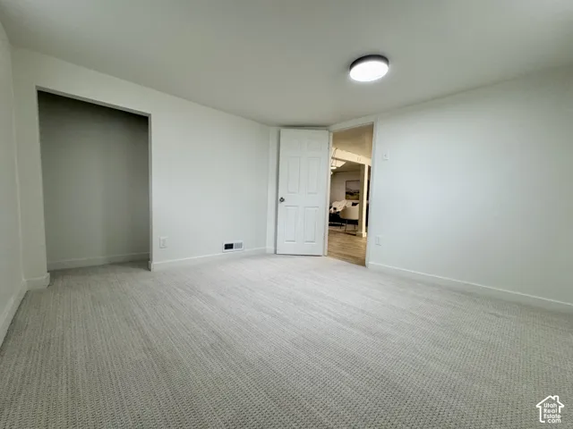 Basement level bedroom 1 with new fresh carpet.