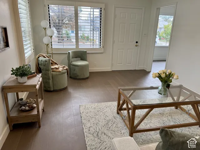 Large and light front living room with plantation shutters, real wood flooring and huge windows.