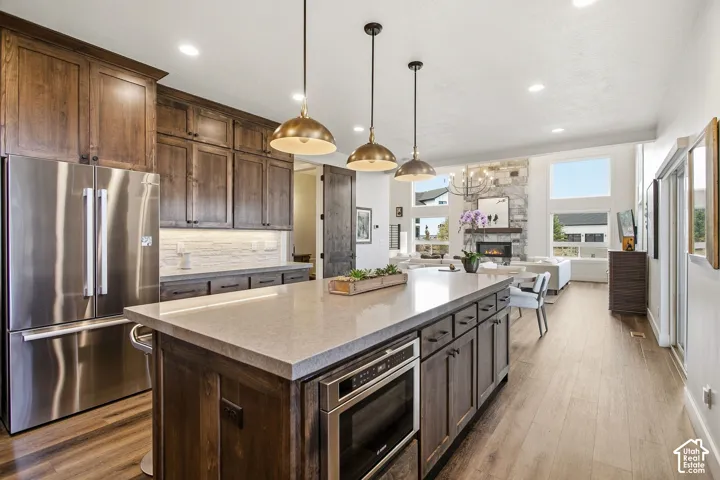 Spacious kitchen island with a light-toned countertop and integrated microwave