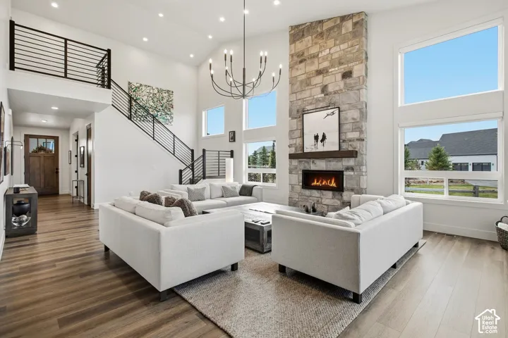 Vaulted ceilings and wood-finish flooring complement the stone-clad fireplace with a built-in hearth