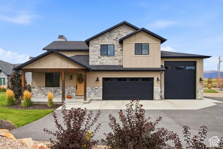 Stone and siding exterior with dark trim accents