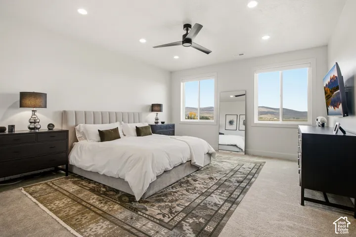 Recessed lighting, ceiling fan, and carpeted flooring