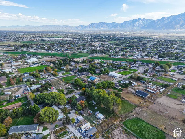 Aerial perspective showcasing the surrounding valley landscape and prominent mountain backdrop