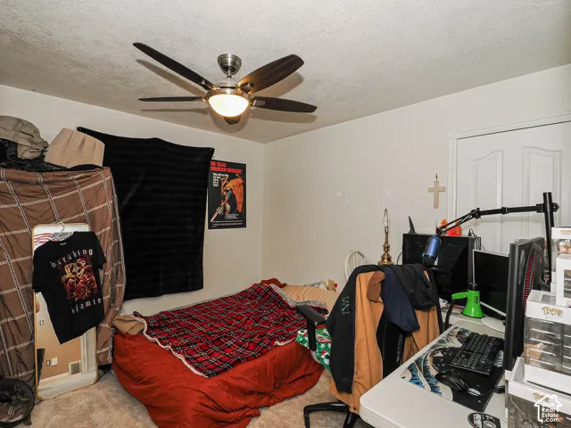 Room featuring neutral-toned carpeting, white interior doors, and a ceiling-mounted fan with integrated light fixture