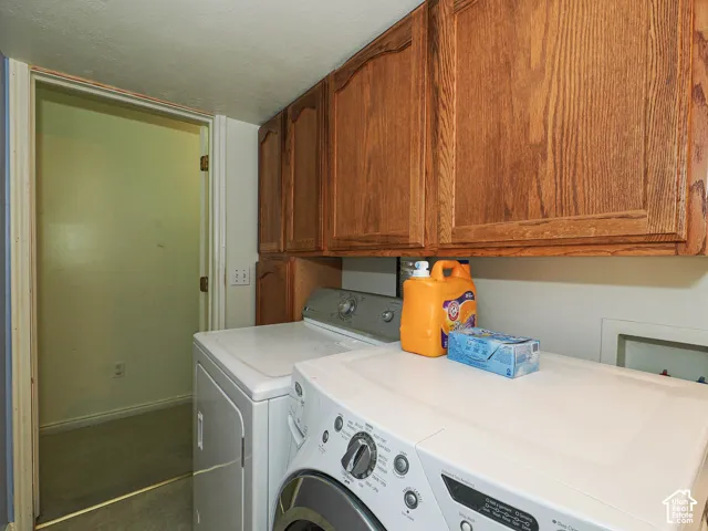 Wall-mounted oak cabinetry with raised-panel doors and dedicated appliance hookups