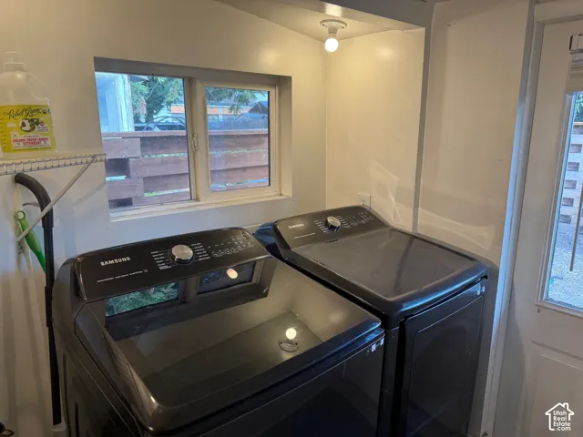 Laundry area featuring a dedicated recessed ceiling light, dual-pane window, wire shelving, and external door access