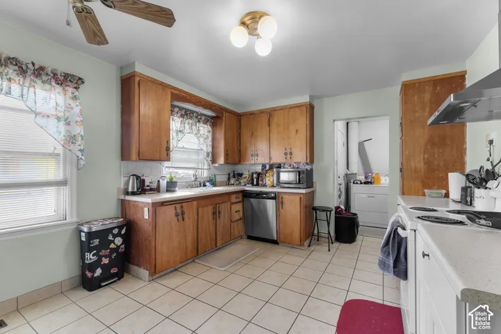 Kitchen featuring wood cabinetry, stainless steel dishwasher, tile flooring, and a flush-mount ceiling light fixture