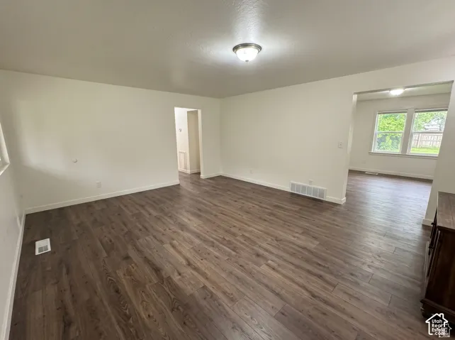 Neutral interior featuring wood-finish flooring, crisp white wall paint, and ceiling-mounted dome lighting