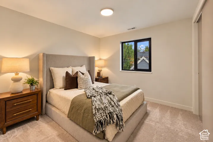 Neutral interior walls, wall-to-wall carpeting, window with dark-toned frame, and ceiling-mounted light fixture