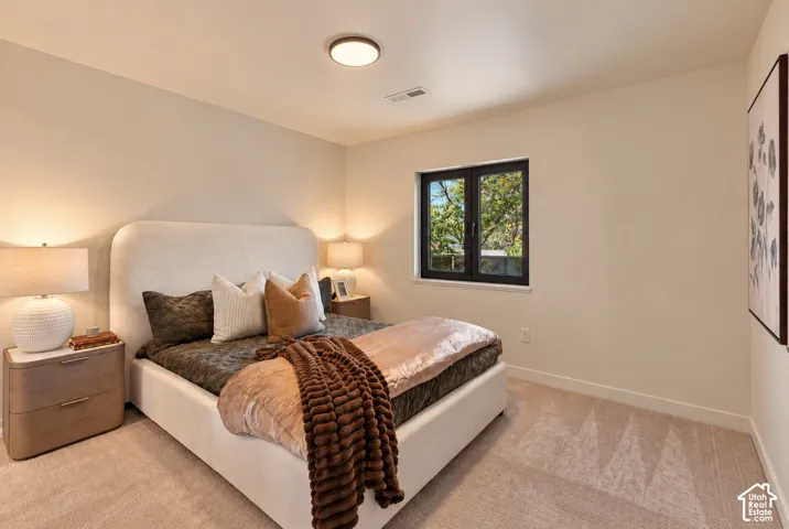 Neutral-toned carpeting, flush-mount circular ceiling lighting, and dark-framed window