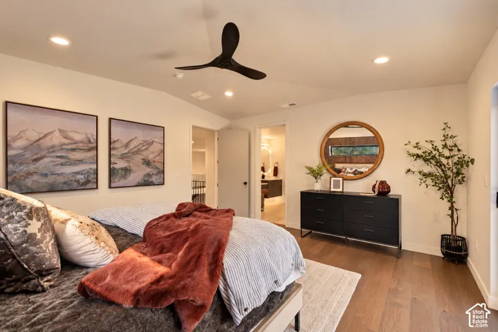 Wood-finish flooring, recessed lighting, and a matte black three-blade ceiling fan