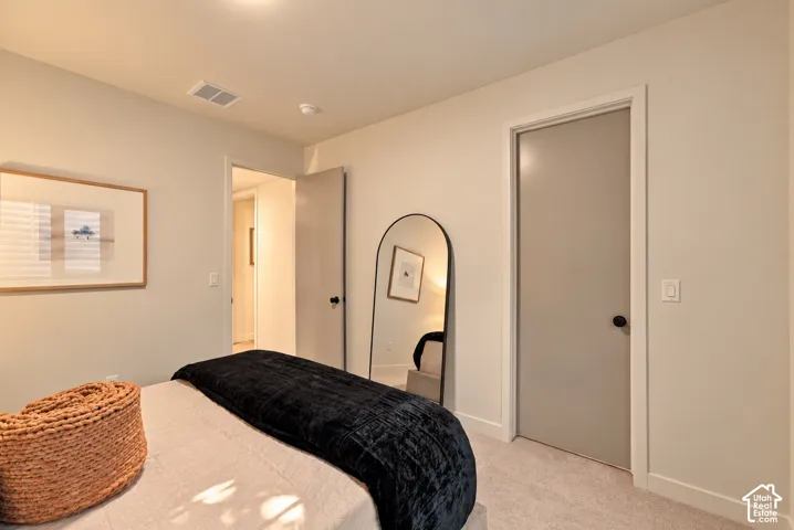 Neutral-toned interior featuring wall-to-wall carpeting, solid-core interior doors, and matte black door hardware
