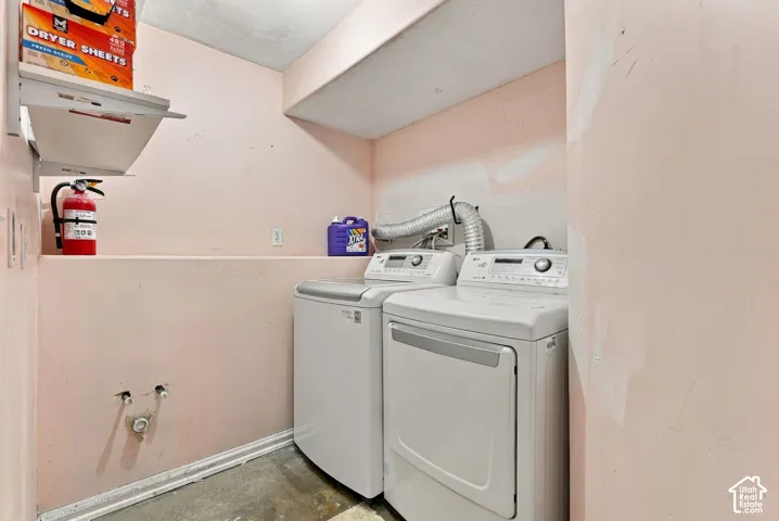 Laundry area featuring a dedicated recessed nook, overhead storage shelving, and plumbing hookups for appliances