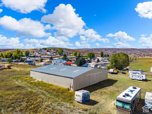 Metal-sided industrial building featuring a pitched metal roof and large sliding doors