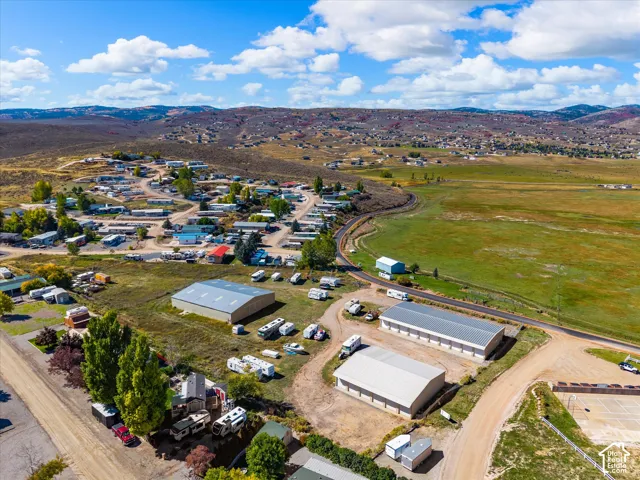 Expansive rural landscape with scattered residences, multiple outbuildings, and a tennis court