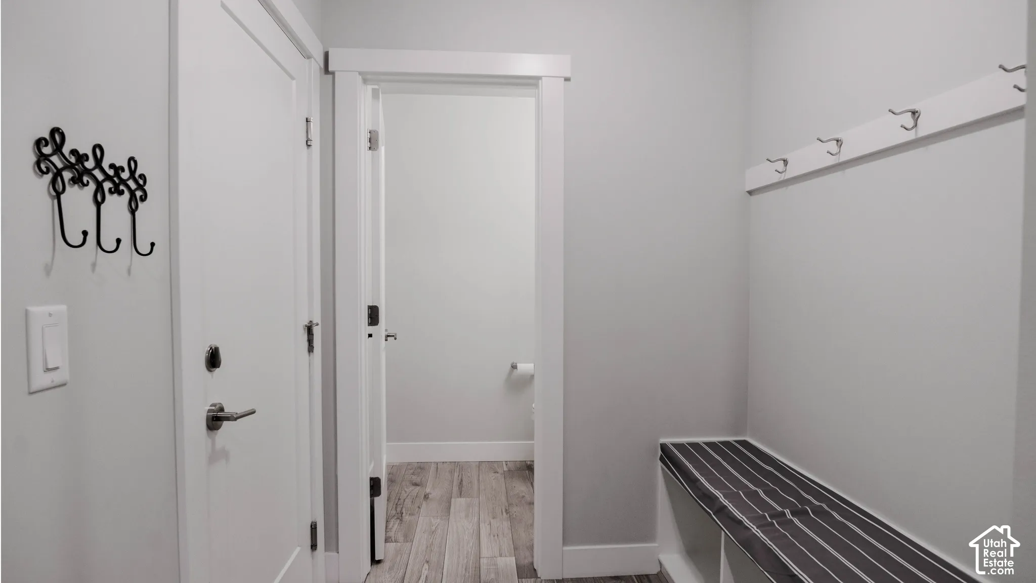 Built-in bench with integrated storage and wall-mounted garment hooks