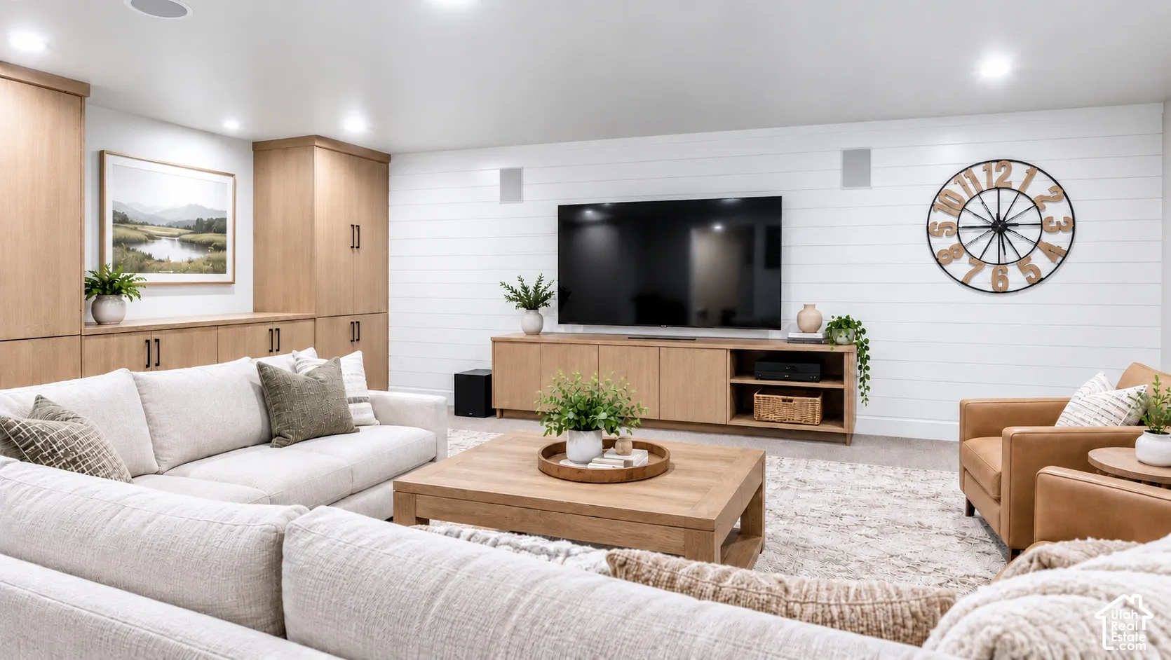 Custom built-in wood cabinetry, horizontal plank wall detailing, and recessed ceiling lighting