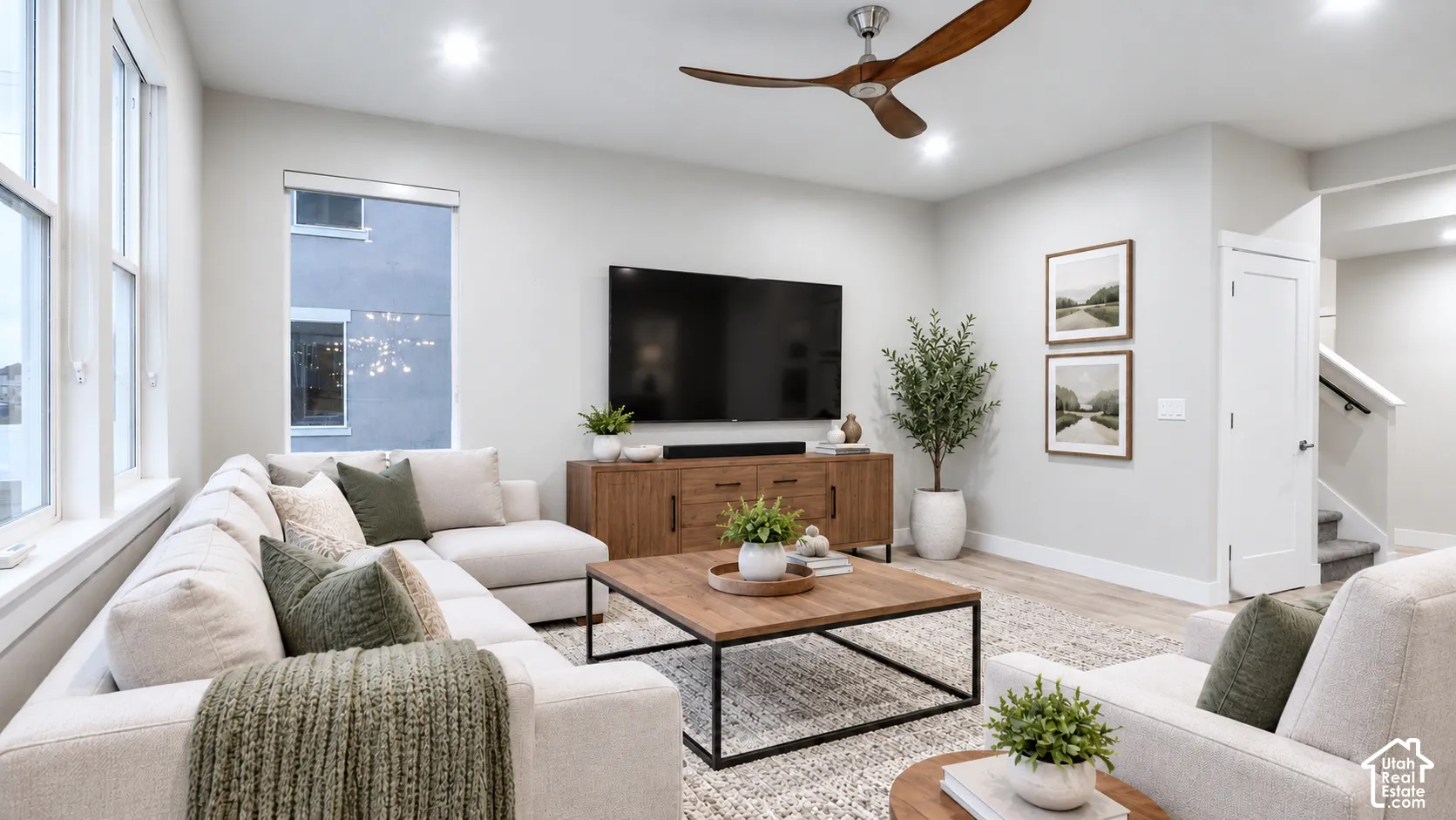 Living area featuring recessed lighting, a modern three-blade ceiling fan, multi-pane windows, and  LVP flooring