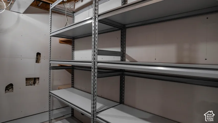 Storage area featuring industrial-grade metal shelving units and drywall partition walls