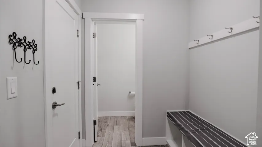 Built-in bench with integrated storage and wall-mounted garment hooks