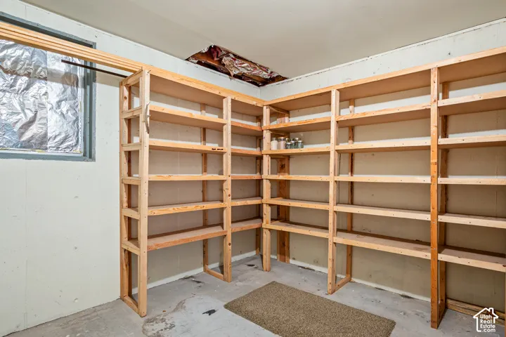 Custom-built, multi-tier wood shelving unit with extensive storage capacity