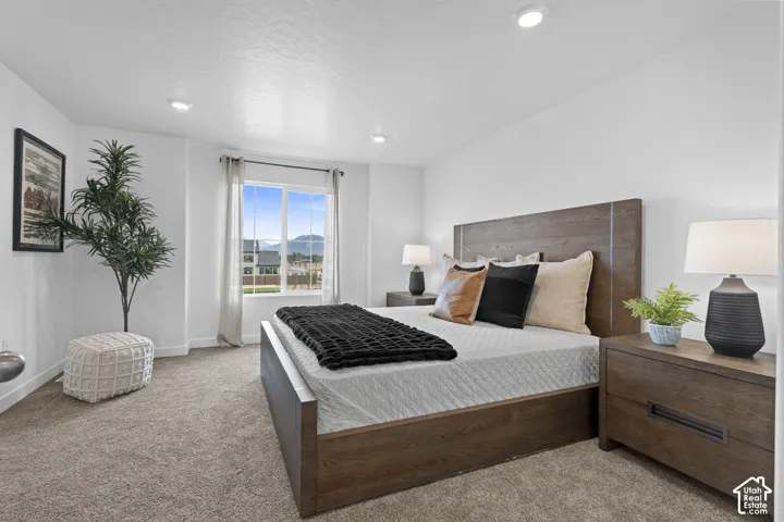 Neutral interior featuring recessed lighting, carpeting, and a large window with mountain scenery