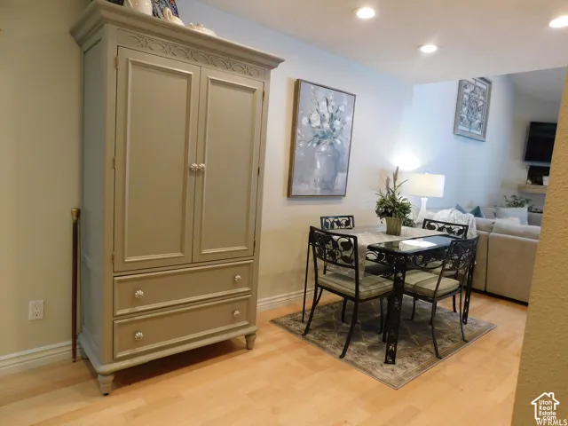 Built-in painted wood cabinetry with decorative detailing and integrated drawers, complemented by wood-finish flooring and recessed ceiling lighting