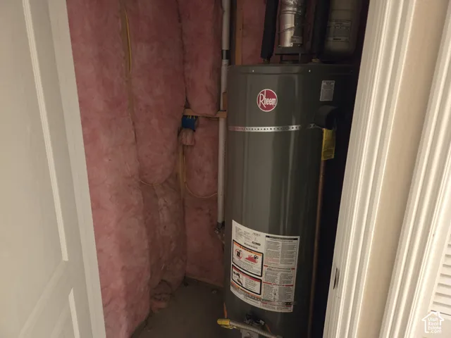 Rheem tank-style water heater housed within an insulated utility alcove