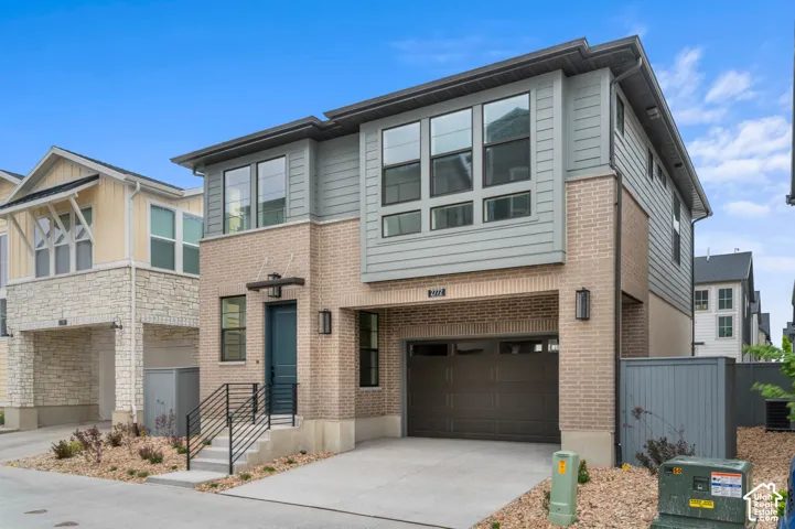 Modern exterior featuring a brick and horizontal siding fa