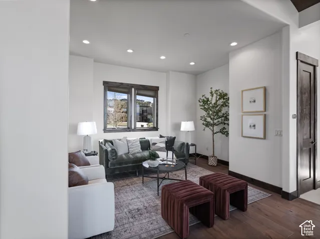 Recessed lighting, wood-finish flooring, and dark-stained wood door and window casings