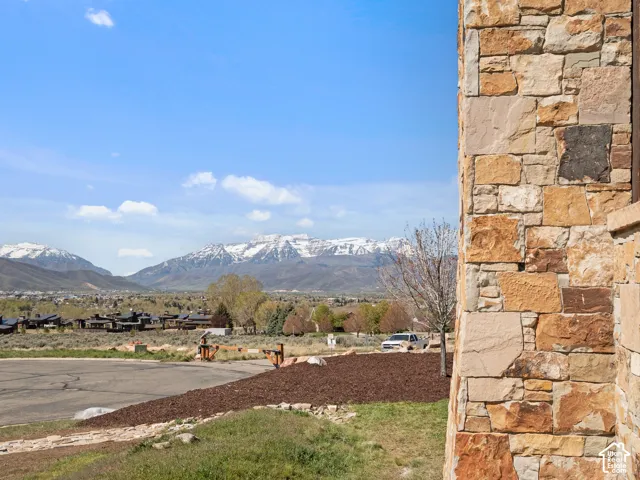 Exterior featuring stacked stone masonry and mountain range backdrop