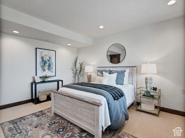 Room featuring wall-to-wall carpeting, recessed lighting, and a circular wall-mounted mirror