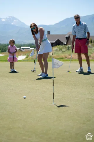 Professional-grade putting green featuring mountain backdrops and expansive terrain