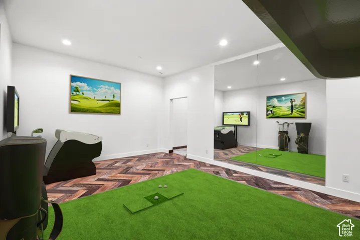 Interior space featuring herringbone-patterned flooring, wall-to-wall mirror paneling, and recessed ceiling lighting