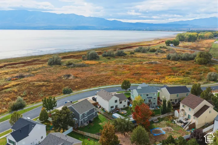 Aerial perspective featuring waterfront exposure, expansive natural landscapes, and a backdrop of mountain ranges