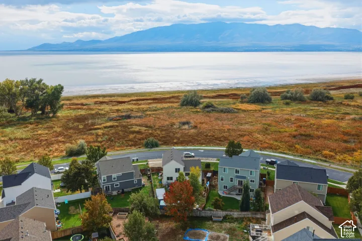 Aerial perspective featuring multi-level residential structures, expansive open-space topography, and mountain backdrop