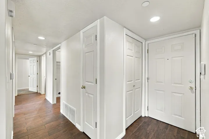Entryway featuring wood-finish flooring, recessed lighting, and multiple interior paneled doors