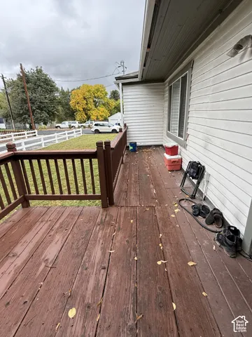 Exterior deck featuring wood plank flooring and a wood railing