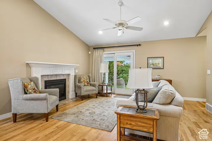 Vaulted ceiling featuring a central ceiling fan and neutral wall finishes