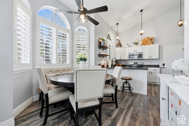 Vaulted ceilings, wood-finish flooring, plantation shutters, arched windows, and white cabinetry