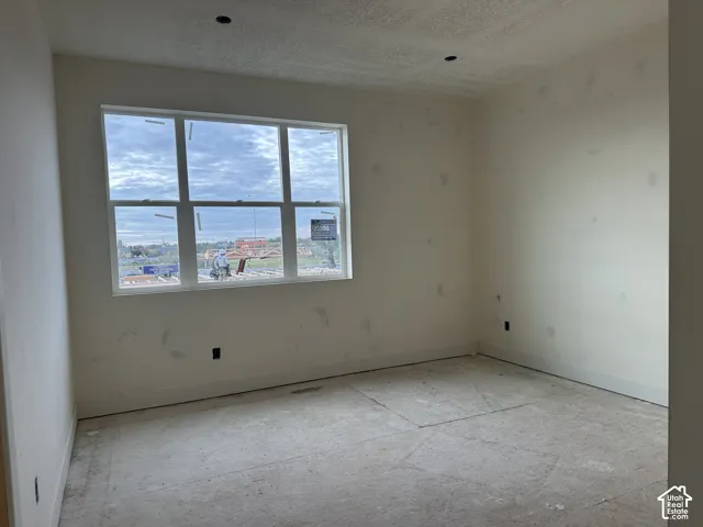 Interior room featuring large multi-pane window with exterior scenery and recessed lighting fixtures