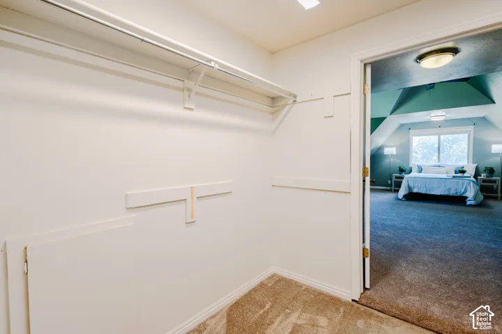 Storage space featuring wall-mounted shelving and a dedicated access panel