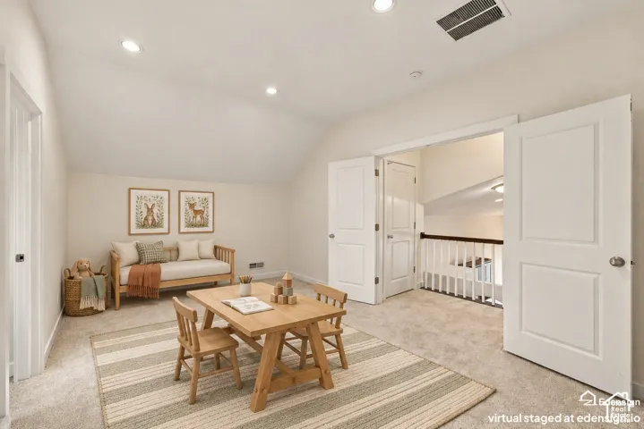 Sloped ceiling featuring recessed lighting, neutral wall paint, wall-to-wall carpeting, and double doors opening to a railed landing