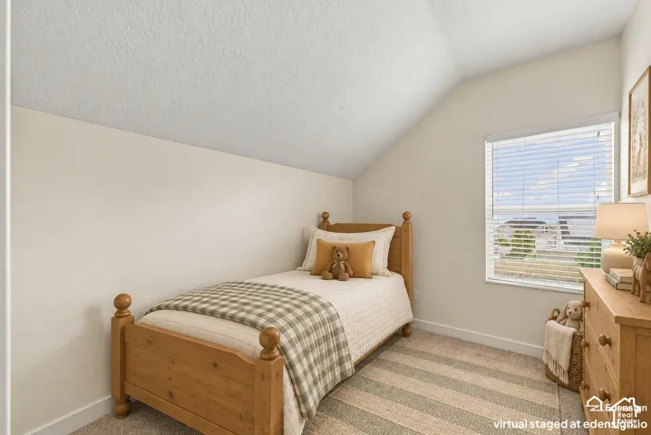 Vaulted ceiling with neutral wall finish and window featuring horizontal blinds