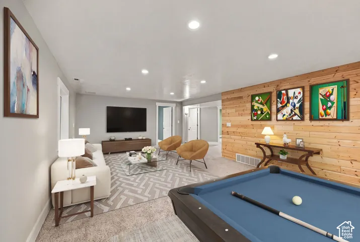 Interior space featuring horizontal wood plank accent wall, recessed lighting, and wall-to-wall carpeting
