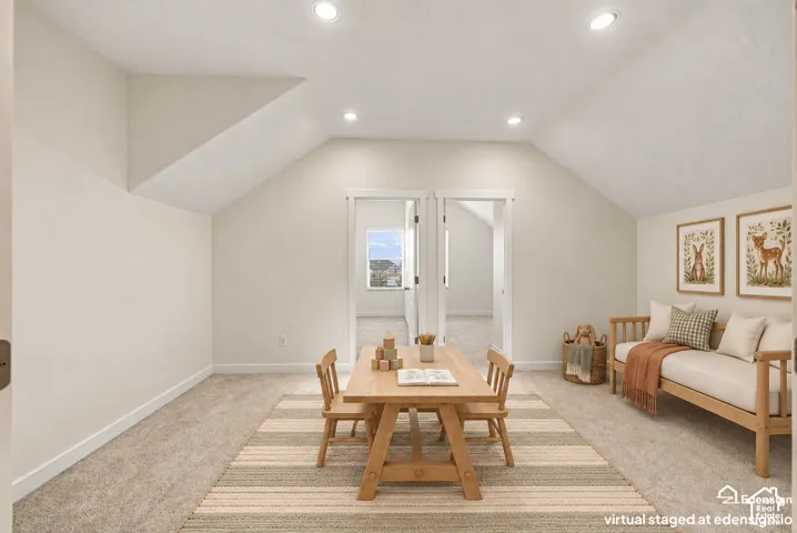 Vaulted ceilings, neutral wall tones, recessed lighting, and carpeting