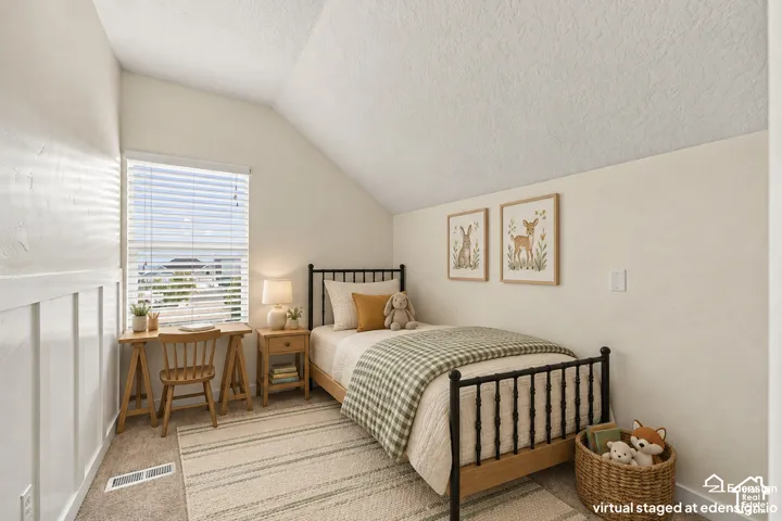 Vaulted ceiling, wall-mounted board and batten wainscoting, and large window with integrated blinds
