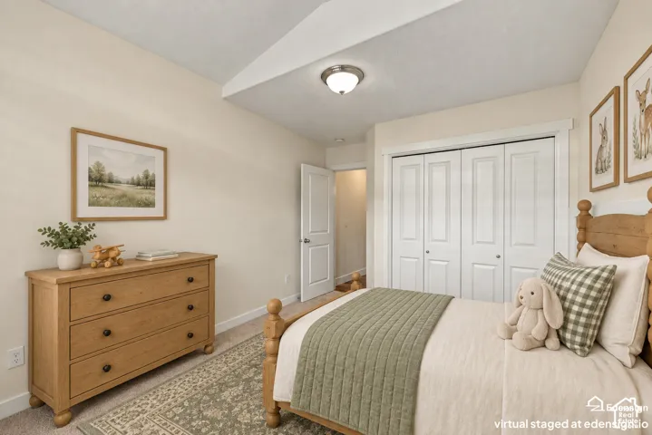 Vaulted ceiling with a central flush-mount light fixture and floor-to-ceiling bi-fold closet doors