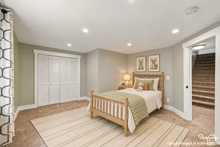 Neutral-toned interior featuring recessed lighting, carpeted flooring, and a four-panel louvered closet door