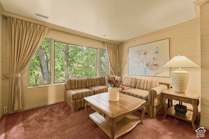 Primary Suite large sitting area with picture windows for nature views.